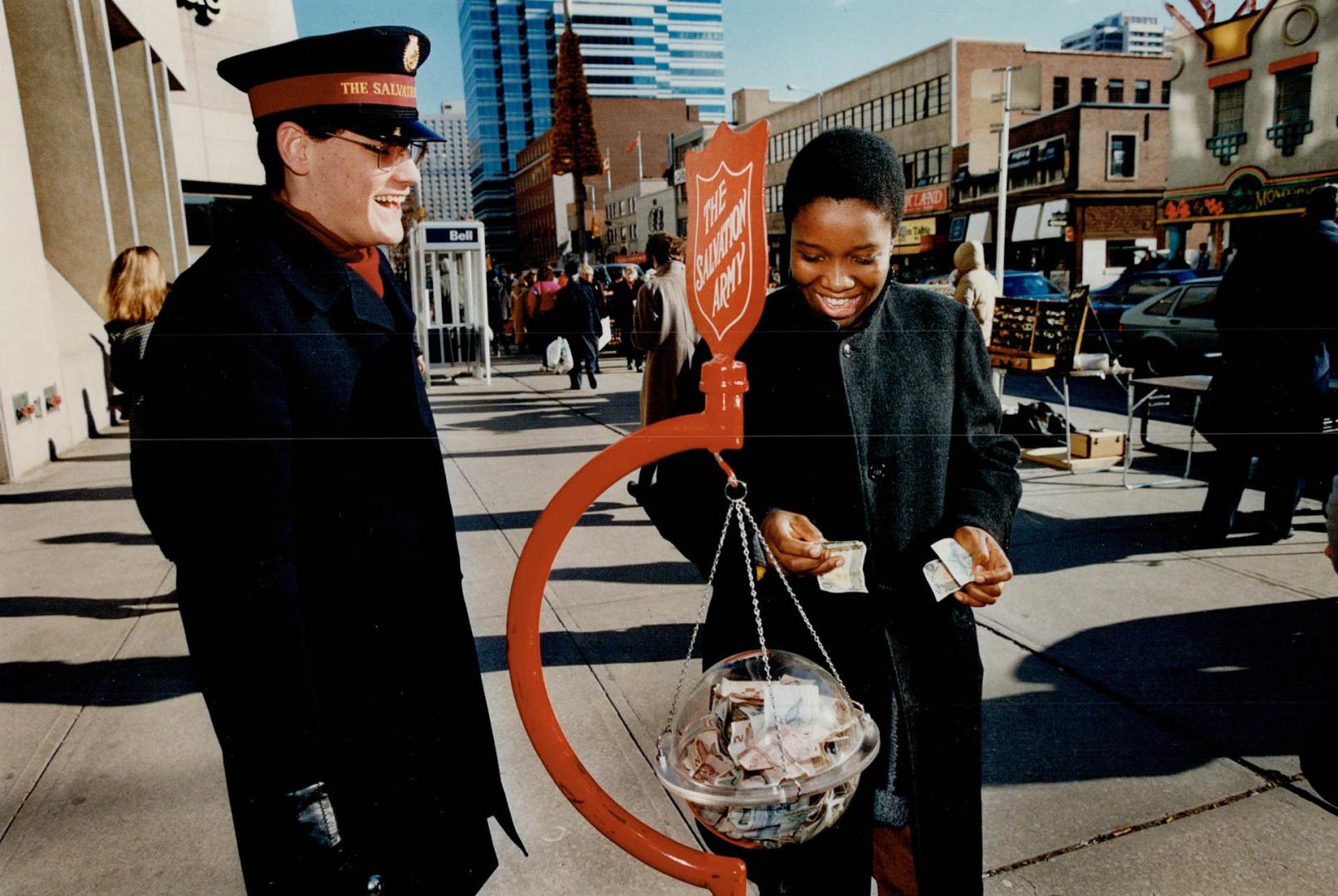 They give and give - to the tune of more than $300,000 a year - at the Salvation Army kettles around Metro staffed by cadets like Dale Lewis, middle, and Mark Guyler