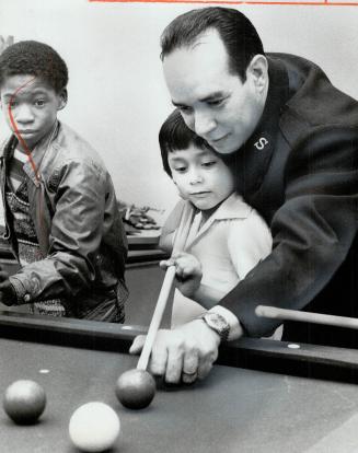 Salvation Army's Pedro Cordoba: John Gonzalez 6, gets a snooker lesson