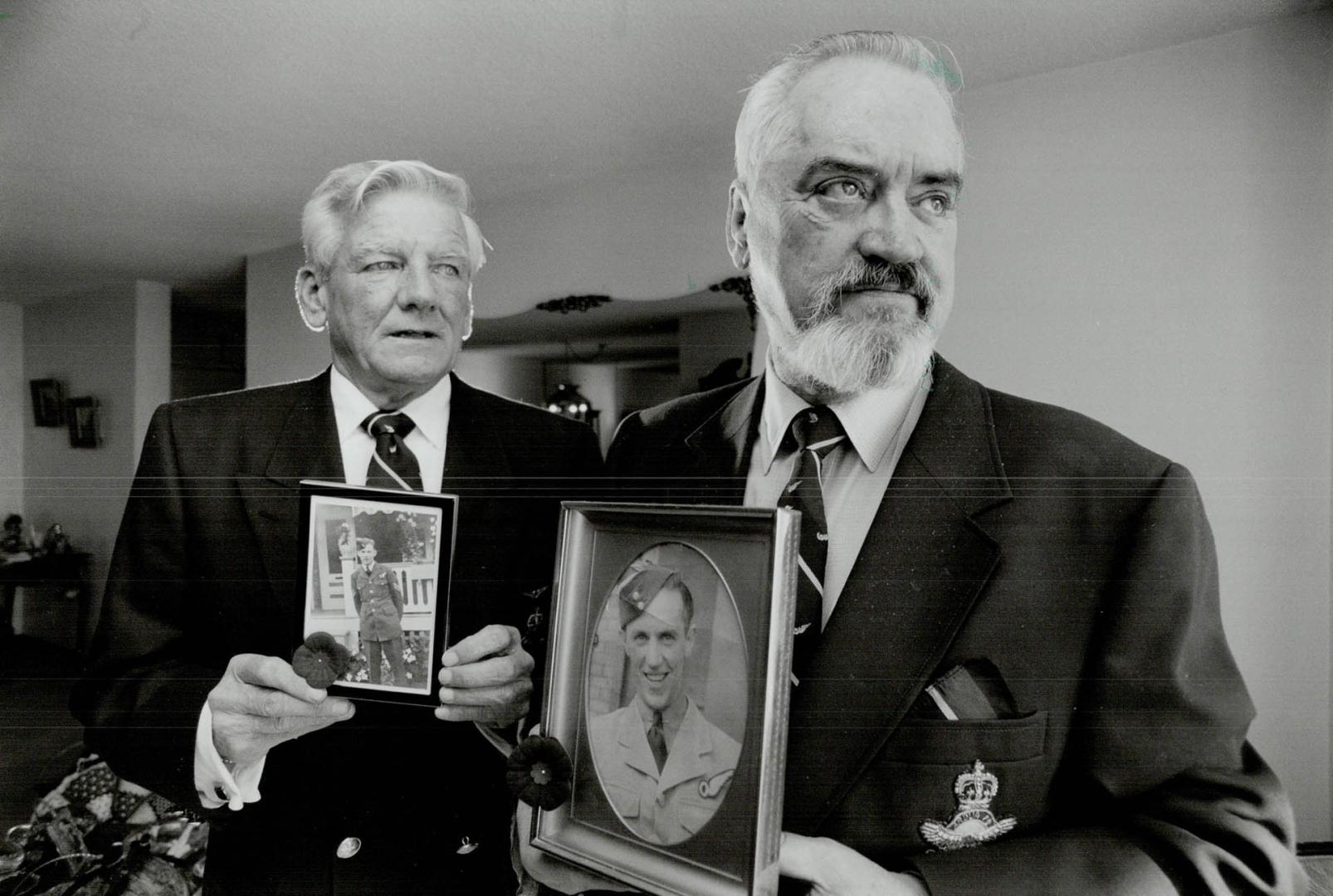 Clem Pearce, right, and Jack Wallbank, who flew wing to wing in World War II hold pictures of their brothers who didn't come home