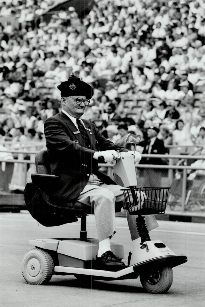 On Parade: G.E. Lucas on his scooter, above, and pipe-smoking Murray wilkes were among 6,000 veterans in yesterday's Warriors' Day Parade