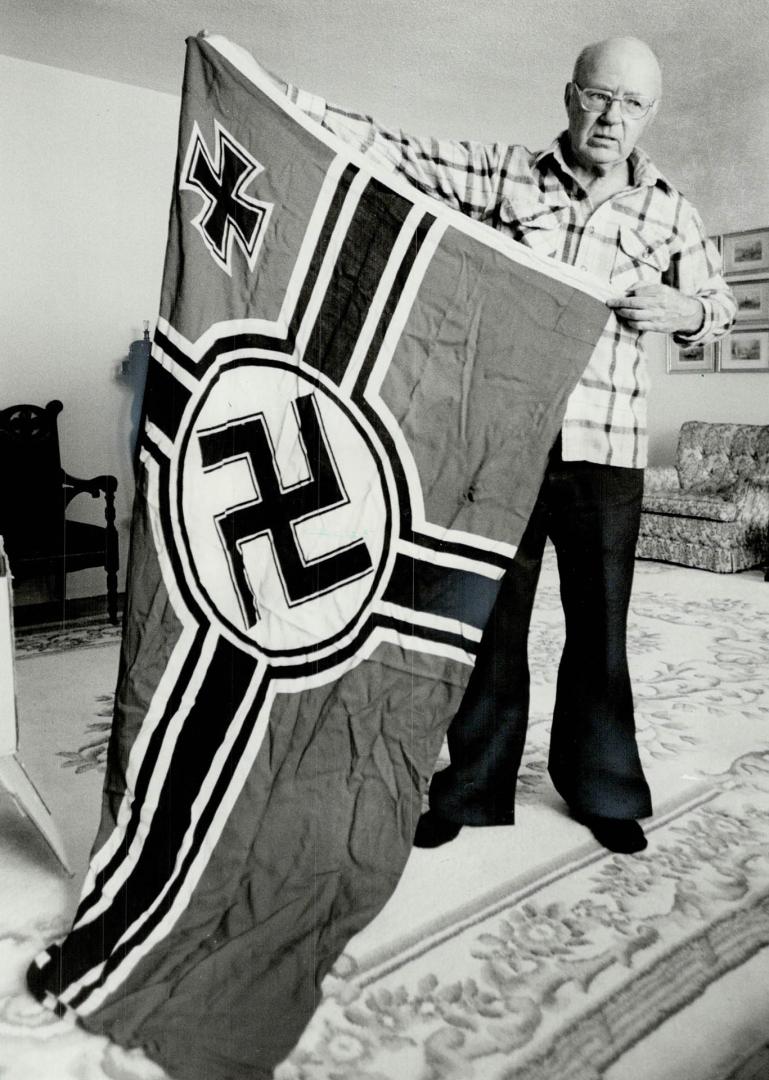 Spoils of war: Martin wearing camouflage net (far left), displays medals and pistol he used in battle, and with captured Nazi flag