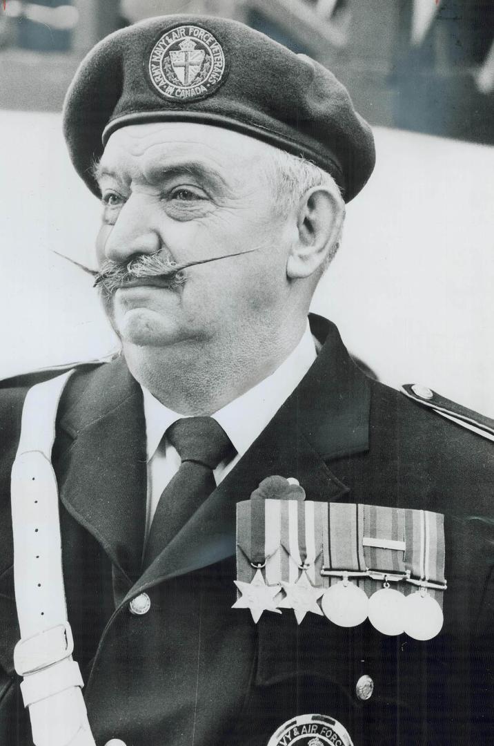 Moustache Bristling, President Ben Phoenix of the Army, Navy and Air Force 306 Owls Unit, stands at attention during 11 a.m. service in front of Cenot(...)