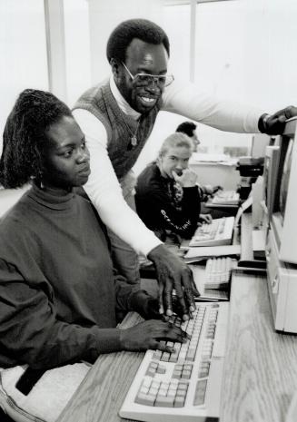 Helping hand: Eric Allen, director of YES program, with client Issia De Haney, at the centre's North York office, where he works with a team of job counsellors