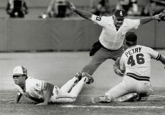 Safe! The Jays' Robbie Alomar slides home safely following a passed ball in the fifth Inning last night at the dome