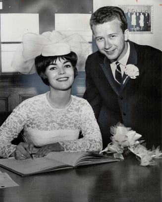 CBC singers Bonnie Hicks and Tommy Ambrose sign register after their marriage in The Peoples Church