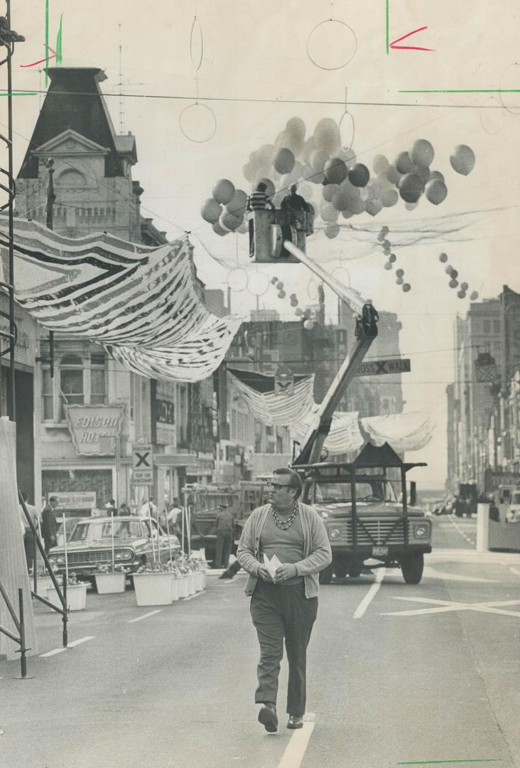 Alderman William Archer inspects decorations today for the second Yonge St