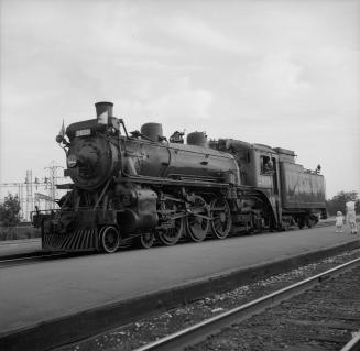 Image shows a track view and a locomotive at the platform.