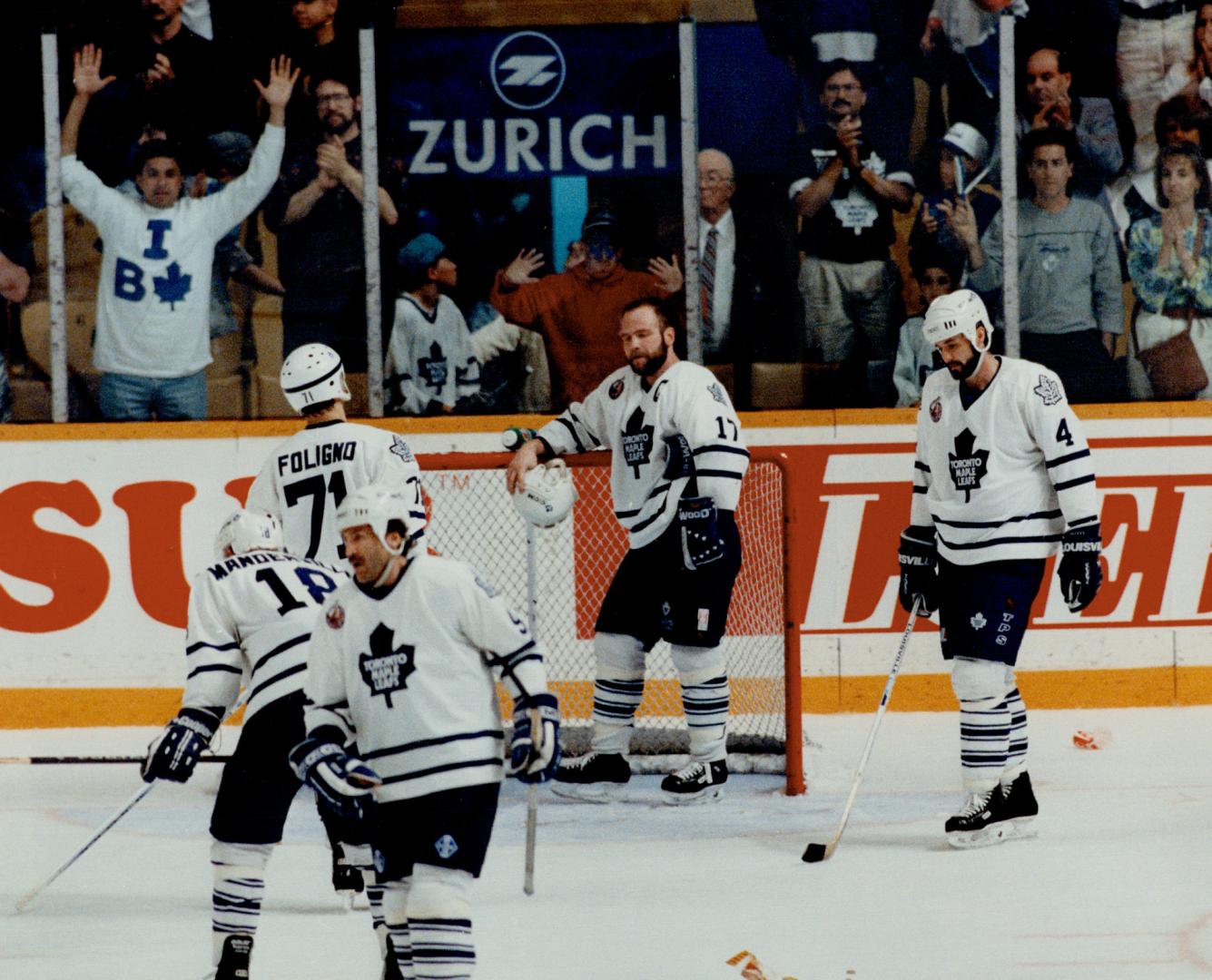 Dejected leafs: Captain Wendel Clark leans on net after final buzzer ends the Leaf's season, with Kent Manderville, left, Mike Foligno, Glenn Anderson, Dave Ellett