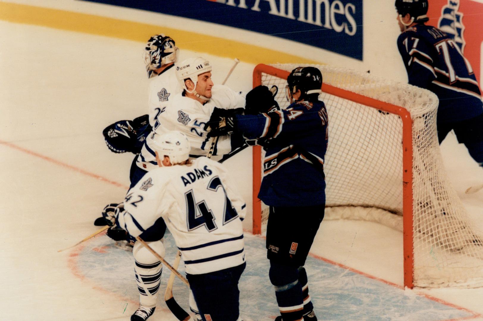 Take that: Leaf defenceman Jason Smith (25) clears Washington's Jaroslav Svejkovsky away from net as Kevyn Adams and Felix Potvin follow the play