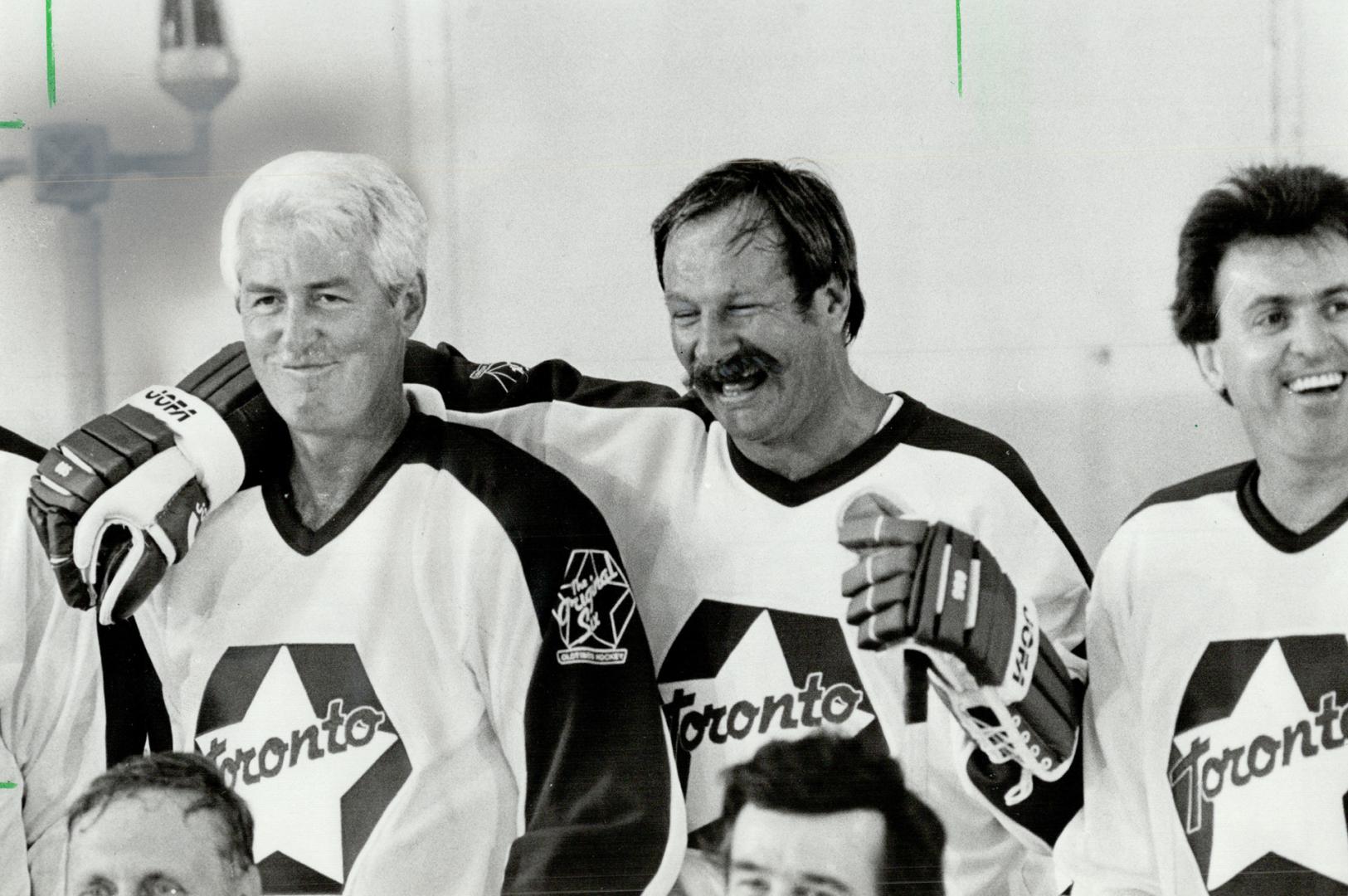 Old friends: Former Maple Leafs Eddie Shack and Billy Harris share a few jokes and memories from the past as they gather with other oldtimers for a team picture yesterday