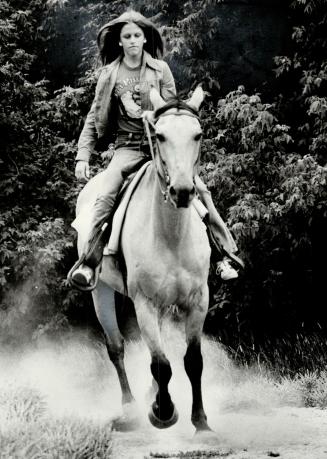 Julie Morningstar, rides Digger down one of the trails from Rouge Hill Stables, Scarboro