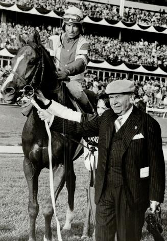 Proud moment: Owner John deWitt Marsh of Virgina poses in winner's circle with Majesty's Prince and jockey Laffit Pincay after Rothmans International at Woodbine