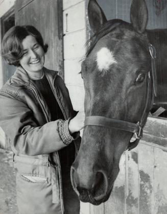 Horses never had it so good. Erika Winkelmann, 22, flashes smile at Bye Bye Fifi, 3-year-old filly she is training. Erika is third woman trainer to be licensed on Ontario thoroughbred circuit