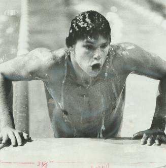 Gasping for breath, Steve Pickell of Vancouver's Dolphin Swim Club climbs out of pool after he won 50-metre freestyle race during Canadian winter swim(...)