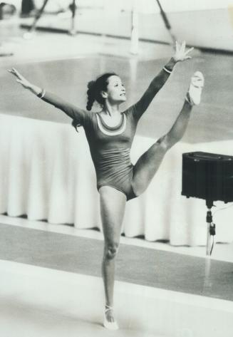 She Bows Out -- Gracefully. Lise Arsenault, 22, performs optional exercises for 17,000 spectators at Montreal Forum yesterday in helping Canada's wome(...)