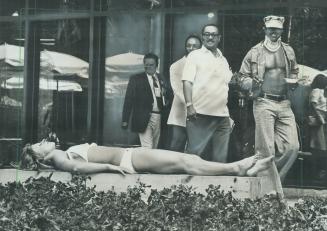 Swimsuited competitors lure crowds of spectators not only in the pool, a sunning Polish athlete finds at Olympic Village