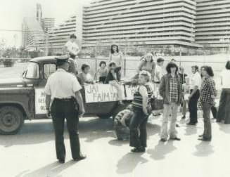 Hungry people demanding food. A group of homeless welfare recipients mill around the main gate at Olympic Village yesterday. They arrived in pick-up t(...)