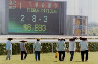 At left, women stroil around the course after each race, delicately tamping down clumps of dislodged turf with their feet