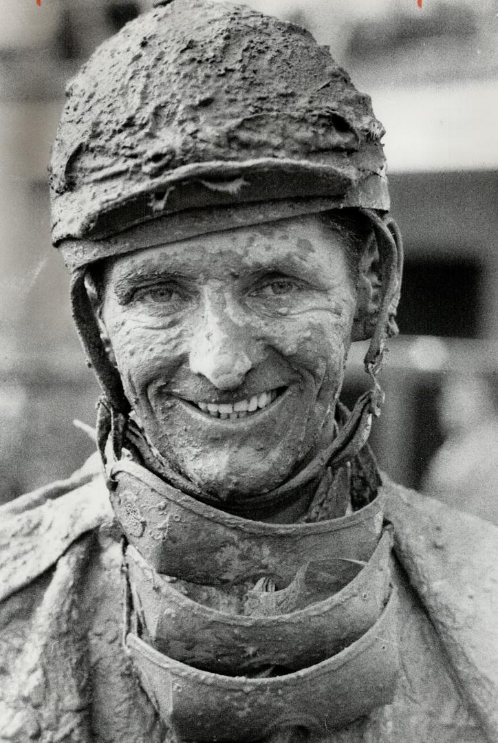 Muddy going: Jockey Chris Rogers used up three separate sets of goggles in attempt to keep seeing during running of fifth race at Woodbine racetrack yesterday