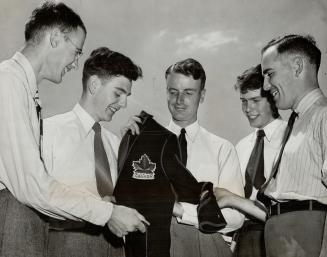 Toronto men bound for Olympics seen admiring a Canadian blazer, are from left, Jerry Fairhead, Dick Townsend, Paul McLaughlin, captain, John Robertson(...)