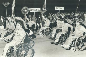 Mexican competitors wave their sombreros at yesterday's opening of the Olympiad for the Physically Disabled