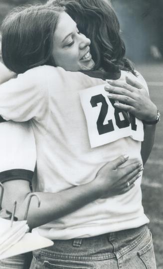 It's a hug for one winner, Dan Lalonde, 19, of North Bay, accepts medal for winning 50-metre senior race from Murray Scott