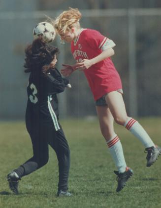 Giving it her all: Angela keenlyside of Danforth Tech, right, hit the ball so hard with a header past Western Tech's Leonor Oliviera her glasses dropped off