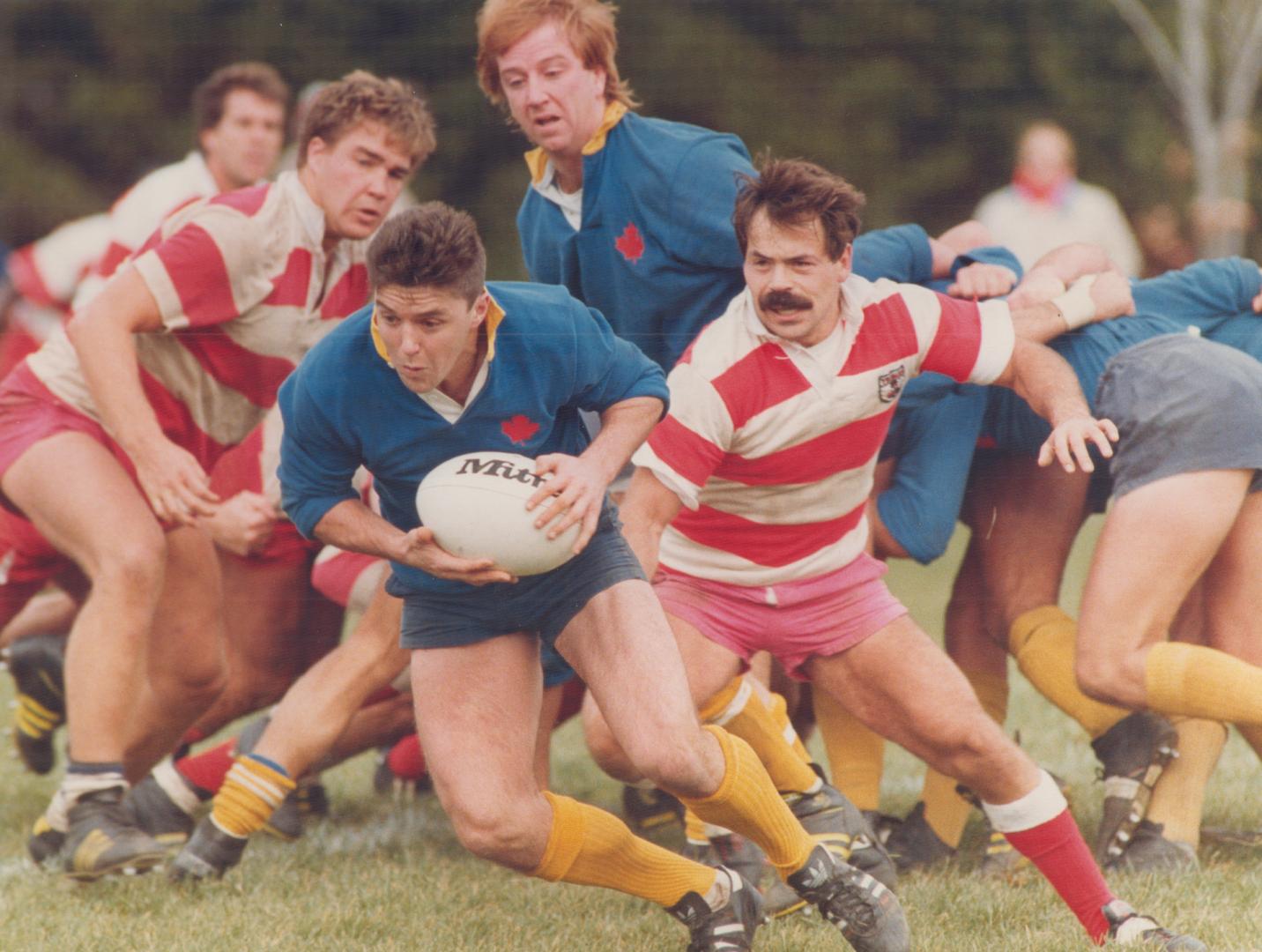 Balmy Beach captain Tony McCann, who scored the game-winning try, eludes York rivals in McCormick Cup rugby finals yesterday. See story E5