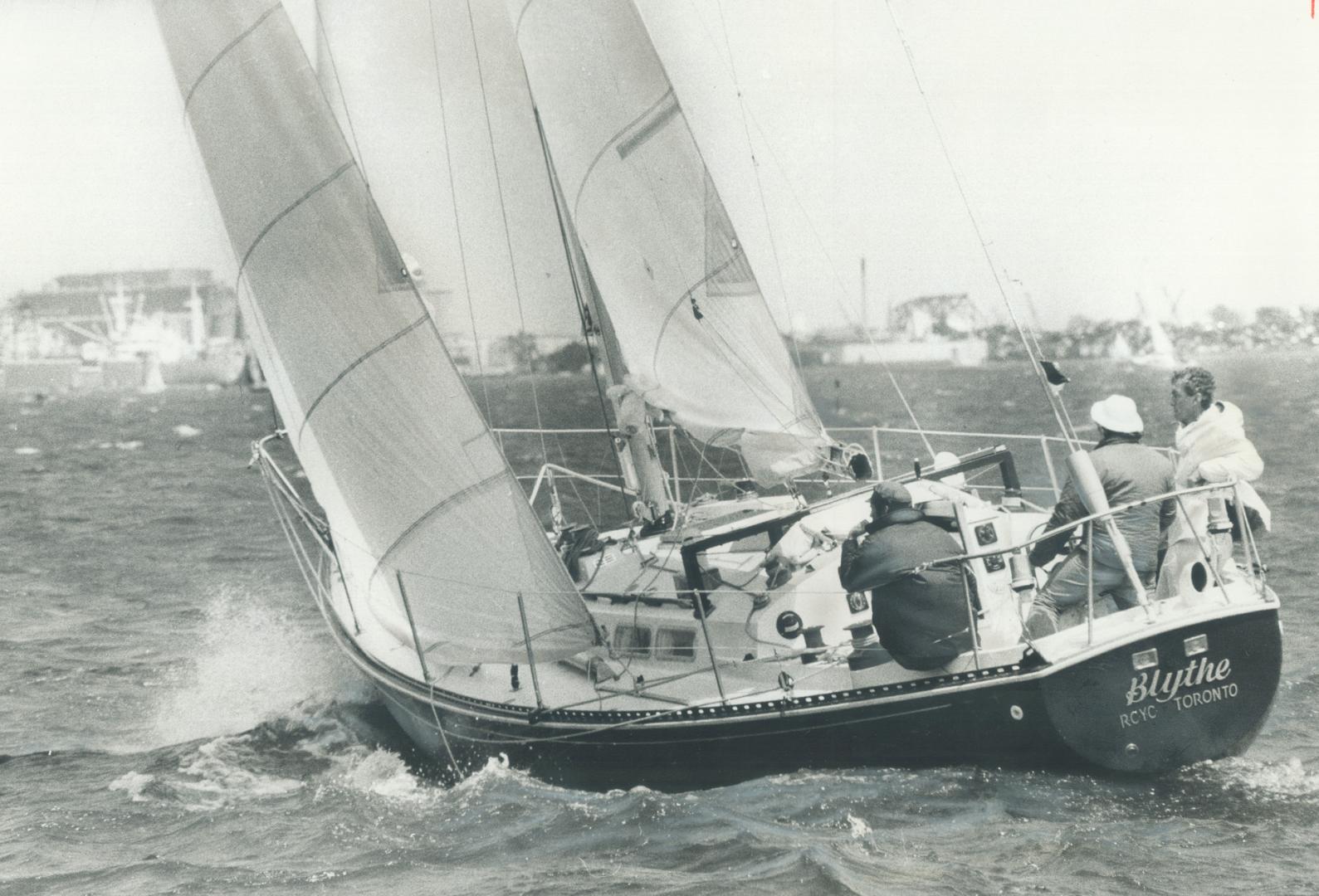 Over the bounding main, The sailing craft Blythe from the Royal Canadian Yacht Club heels over as it goes through the Western Gap into Toronto Bay Sun(...)