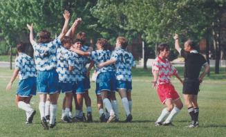 Oh No, Ref' Sam Guercio of Nell McNeil protests as Henry Carr players celebrate goal in Catholic schools soccer final