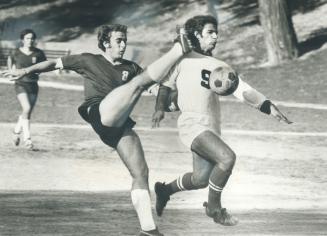 That's just too close for comfort, Bloor's Cesar Pedro misses the ball and nearly kicked Western Tech's Robert Sette during Toronto high school junior(...)