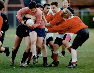 A little help from his friends, Paul Turner of West Hill, struggling against the maul of one of the Black Scots of Macdonald, gets some help from his (...)