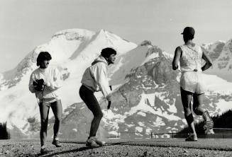 At the halfway point Janet Dick grabs the baton from Carrie Richards, near the Columbia Icefields their stints over, they holler encouragement at team mate Jocelyn Otis