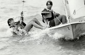 Balancing act: Gordie Anderson (above) keeps as Laser II on course while a student tries out the trapeze, which is used to keep the small boat balanced in racking