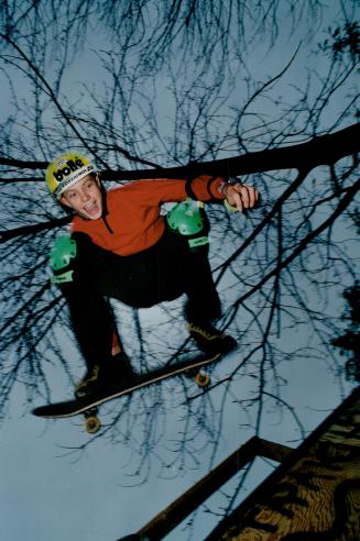 Jay Vaughan, 14, whose nickname is Super Jay, grabs some air as he practices on a skateboard ramp to keep in shape for freestyle skiing