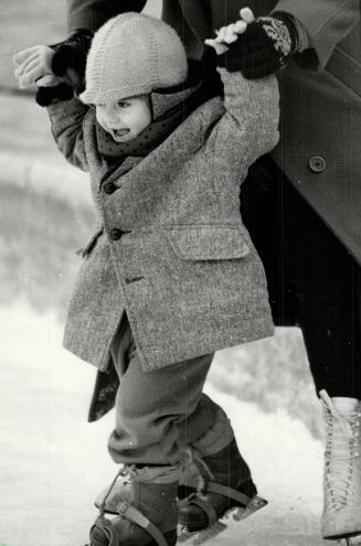 Look ma, no hands!, Two-year-old Devon enjoys zipping along the ice at Harbourfront's skating rink during yesterday's mild weather as his mother, Dale(...)