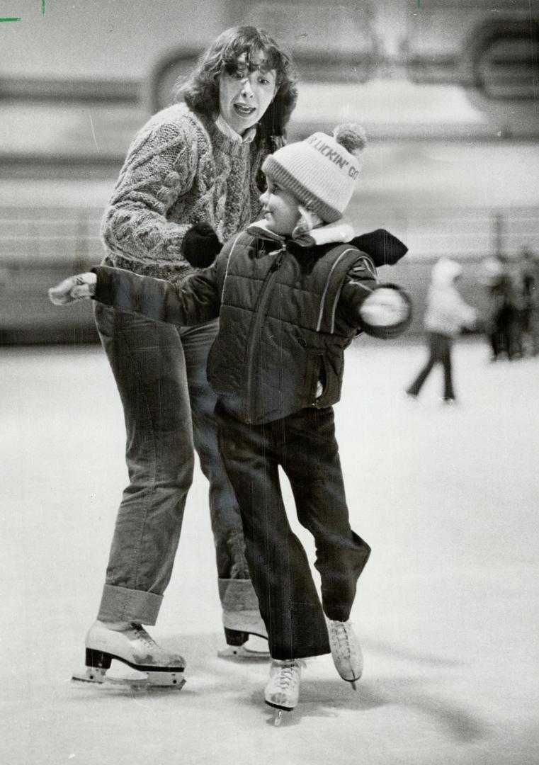 Back on ice: Geri Warren, 21, of Scarborough, fitted with an artificial leg after an amputation following a car crash two years ago, frolics with Rebecca Campbell, 6, in her skating class