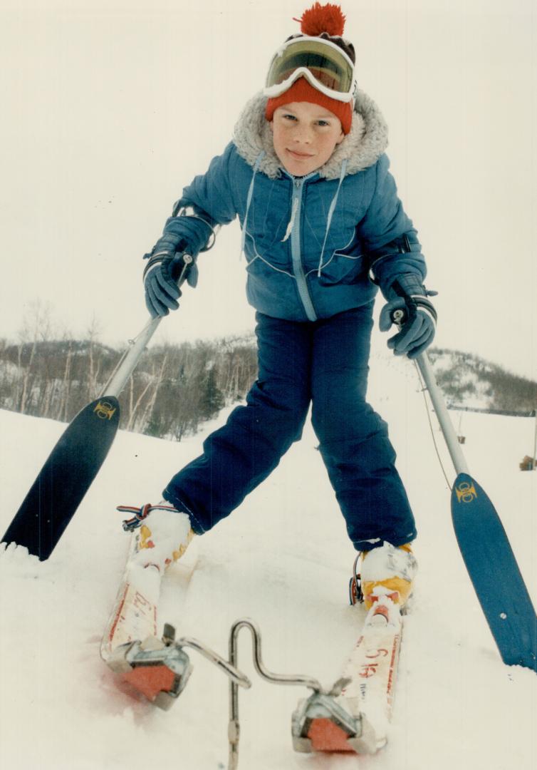 Meeting a challenge: A chrome coupler, called a ski-bra, is attached to the tips of 10-year-old Derek McNamara's sk's to prevent them from crossing