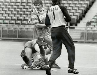 This way up: Jimmy Nicholl of the Blizzard shows a new twist to playing soccer, landing in an awkward position