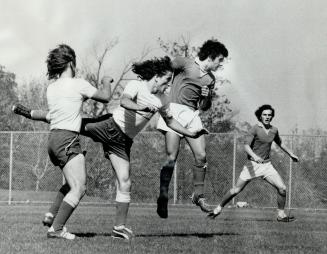 Forming a ballet-like tableau are players from East York Internationals (white shirts) and Vaughan Road Vikings as they give chase to elusive ball dur(...)