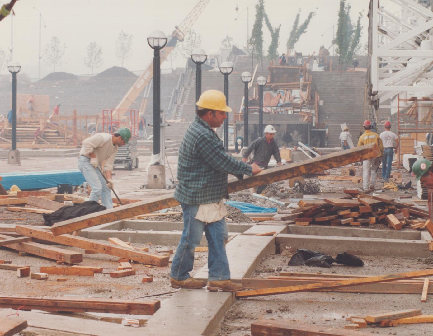 The SkyDome site's west side was awarming with workers today after city council gave a two-day reprieve for completion