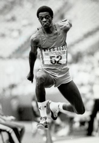 Brazil's Joao De Oliveira flies through the air with his tongue out during his triple jump