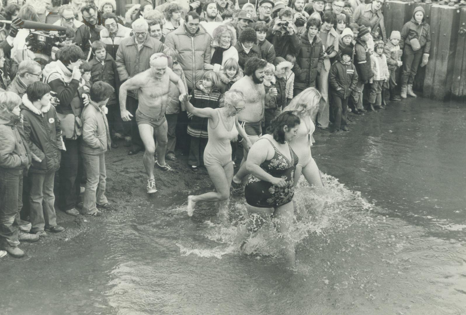 Swimmers hit the 38F, 4C waters of Lake Ontario in the annual Polar Bear Club swim at Van Wagner's Beach in Hamilton