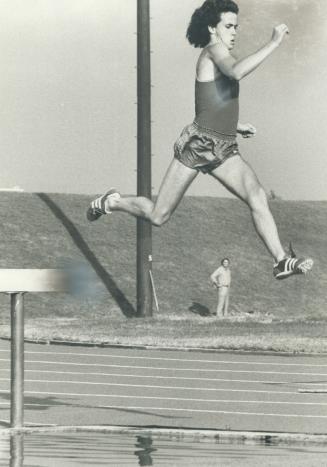 In full flight, steeplechaser Steve Keating leaps hudles at Centennial Stadium as he trains for Canadian team competing today with France's top junior(...)