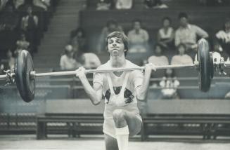 Strain of lifting 55 kilos clearly shows in the face of a determined Steve Burley during Eastern Canadian weightlifting championships at CNE Coliseum (...)