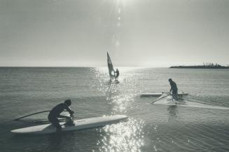 Never say die. Dedicated windsurfers Mike and Jeff Pratt took advantage of Metro's Balmy Indian Summer weather yesterday, launching their boards at Wo(...)