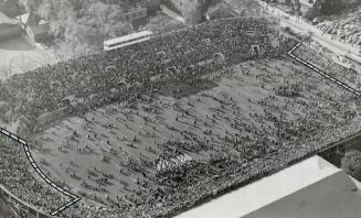 Largest crowd to witness a football game in Canada, 25,153, begins to stream across the field at Varsity bowl Saturday afternoon just after McGill uni(...)