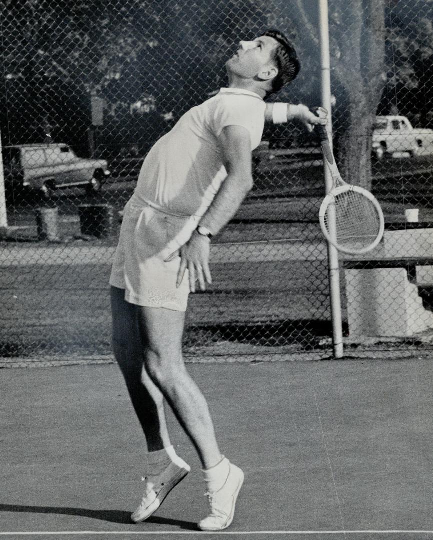 Ken Sinclair (above) skids across the court for a forehand return while Max Ward scans the skies for a tennis ball that should be coming down sometime(...)