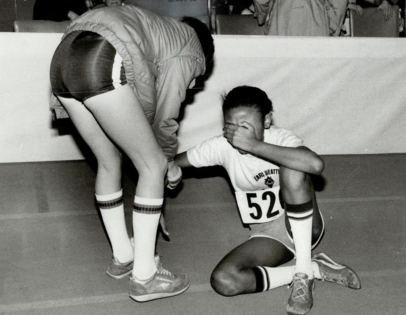 Tears of despair: Sharon John, 14, of Earl Beatty school, sits on track after she came in third in girls 400-metre final at today's public school section of Star Indoor Games