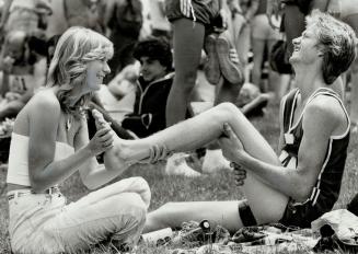 Martin Wikkerink, 22, has feet massaged by his sister, Marcella, 19, after race